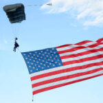 American flag skydiver crashes into beer tent (VIDEO)
